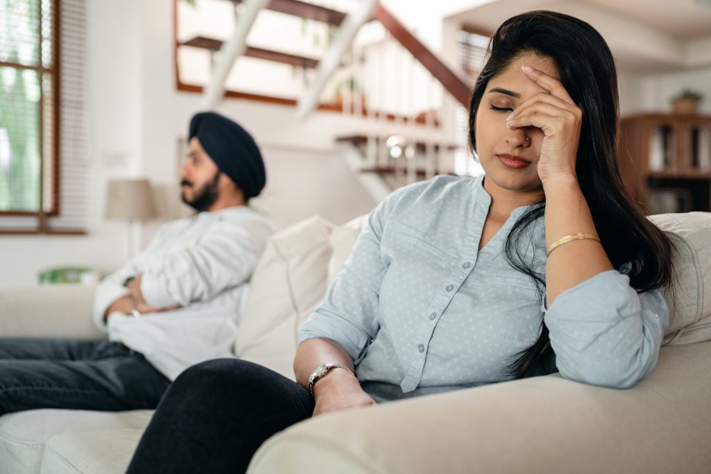 Couple on a couch getting divorced.