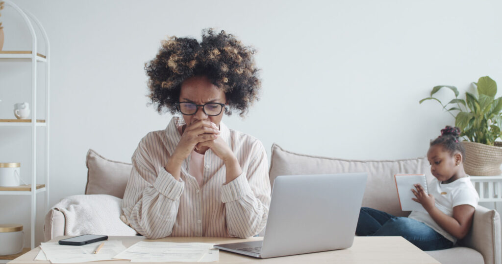 Upset young african woman with frustrated look is reading new bank notification