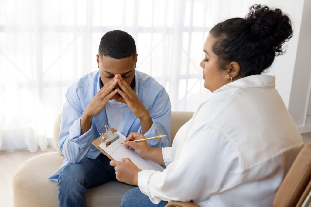 Upset black man going through divorce, attending therapy session