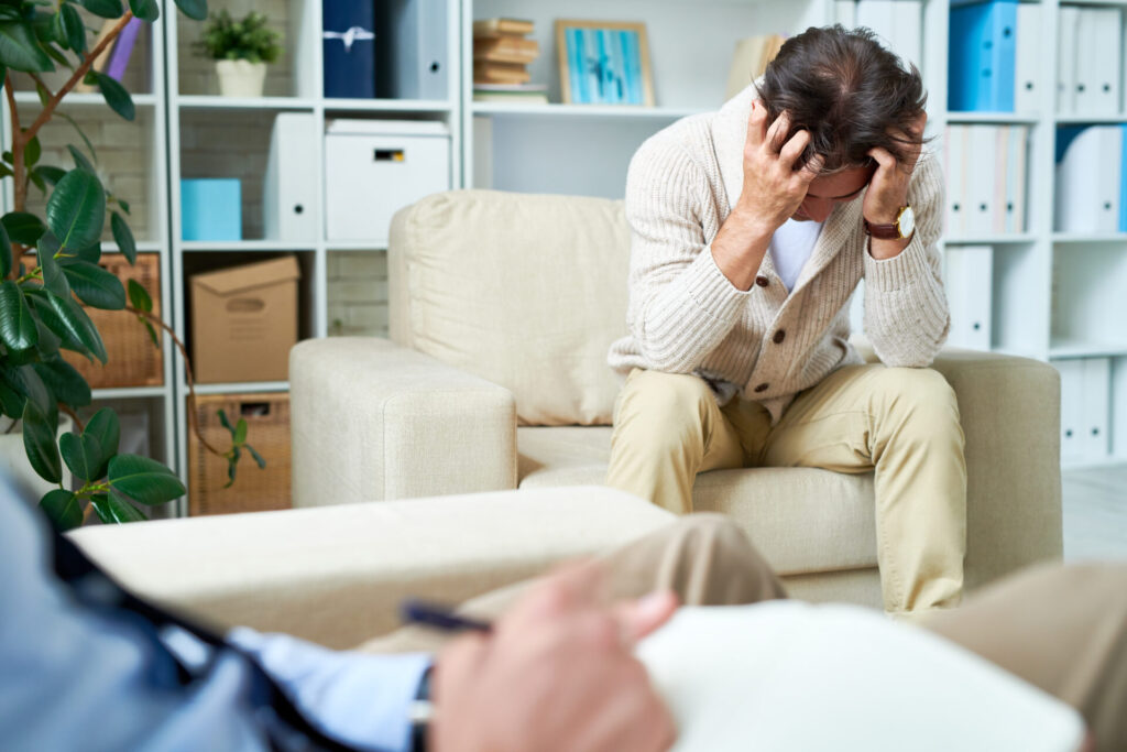 Depressed man at psychotherapy session